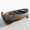 Wooden rowboat embodies coastal vibes, with a touch of vintage