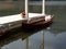 Wooden rowing boat rowboat parking at harbor pier decorating with flower bouquet