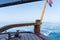 Wooden rudder on small wooden boat and blue sea