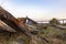 Wooden ruins near a beach under a clear sky