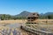 Wooden Rural huts in Chiang Mai with rice field and mountain landscape.