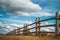 Wooden rustic fence in village and blue sky