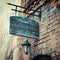 Wooden rustic signboard on aged medieval wall