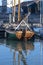 A wooden sailing boat docked, in the fishing post.