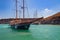 Wooden sailing boat at volcano bay near Santorini island