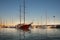 A wooden sailing ship is moored in the port of Mazara del Vallo. In addition, many other sailing ships in the water