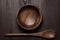 Wooden salad bowl and spoon on table