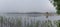 Wooden sauna in the fog in the early morning on the lake Gaxsjon, Sweden