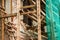 Wooden scaffolding near the old building and a protective mesh