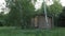 Wooden scandinavian barn house the light is on in the window and birch trees in front of the house. forest cabin in the