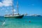 A wooden schooner anchored off a pristine beach on christmas day