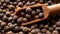 Wooden scoop full of allspice jamaica pepper close-up. Dried berries of the Pimenta dioica tree texture. Organic spices,