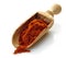Wooden scoop with paprika powder