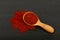 Wooden scoop spoon full of sun dried tomato