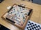 A wooden  Scrabble game board, by Hasbro, on a wooden table