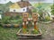 Wooden sculpture flower boxes on the background of a painted house on the playground called `Good Fairy Tale`