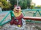 Wooden sculpture on the playground. Smiling bear