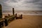 Wooden sea defences on a sandy beach in Cromer, North Norfolk