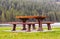 Wooden seat in a park. Picnic in the park. Rest in the open area. Wooden picnic table and seats