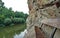 Wooden seat at via ferrata trail above a water