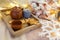 Wooden serving tray with brown ceramic kettle, steaming hot drink mug in a cozy home interior. Food, drinks, toy, gingerbread coo