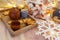 Wooden serving tray with brown ceramic kettle, steaming hot drink mug in a cozy home interior. Food, drinks, toy, gingerbread coo