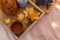 Wooden serving tray with brown ceramic kettle, steaming hot drink mug in a cozy home interior. Food, drinks, toy, gingerbread coo