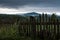 Wooden shabby fence against a mountain landscape