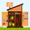 Wooden shed on the lawn with open doors. Gardening tools are stacked inside on shelves and hung on the door. A wooden sign with