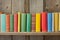 wooden shelf with row of colorful childrens books