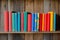 wooden shelf with row of colorful childrens books