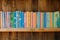 wooden shelf with row of colorful childrens books