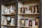 Wooden Shelf of a Shop with Ceramic Vases, Glass Containers and Books