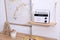 Wooden shelf with stylish radio on white wall indoors