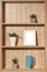 wooden shelf with succulent flowers, cups and empty picture frame. Copy space