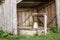 A wooden shelter for a water well site with a bucket