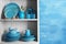 Wooden shelves with blue dinnerware