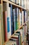 Wooden shelves of books in a library or book shop or bookstore