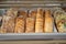 Wooden shelves with fresh bread and baguettes in the supermarket. Products in the bakery section of the store