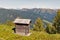 Wooden shepherd toilet with Alpine mountain landscape in Austria.