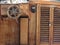 Wooden ship deck with helm and navigation instruments . Particular view of a retro steering wheel of an old sailing vessel