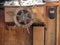 Wooden ship deck with helm and navigation instruments . Particular view of a retro steering wheel of an old sailing vessel