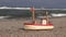 Wooden ship model toy by sea on beach sand
