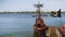 Wooden ship moored at pier with pirate flag and black sails