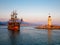 Wooden ship and Old Alanya Deniz Feneri lighthouse in Alanya port at sunset. Popular tourist destination in Turkey