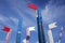 Wooden show jumping barriers with flags on the blue sky background.