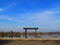 Wooden Shrine Overlooking Lake with Gate