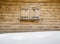 Wooden shutters on a cabin window with snowdrift in forground