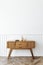 Wooden sideboard table with books and a vase