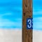 Wooden sign on the beach. number 35